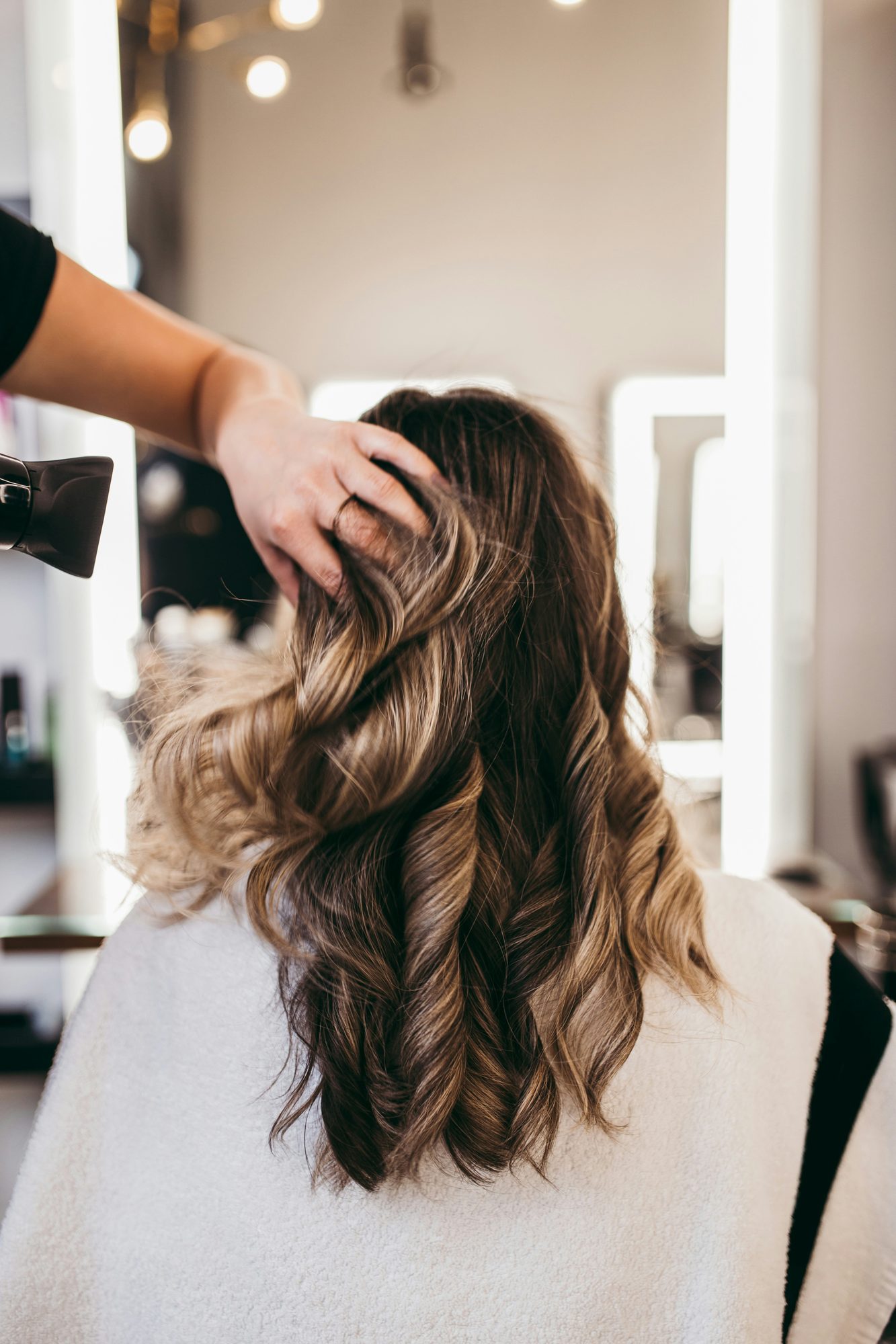Melena larga con ondas y balayage en una peluquería